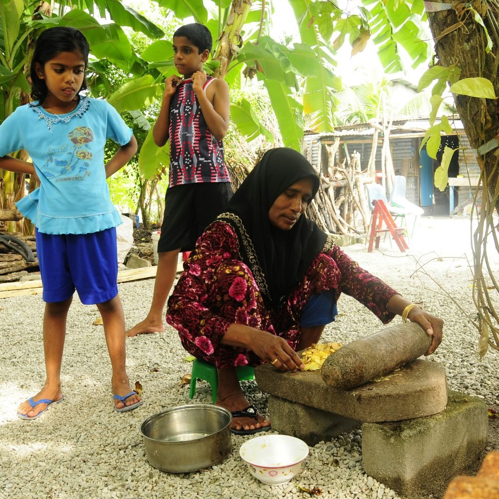 kids enjoying and learning how to grind spices