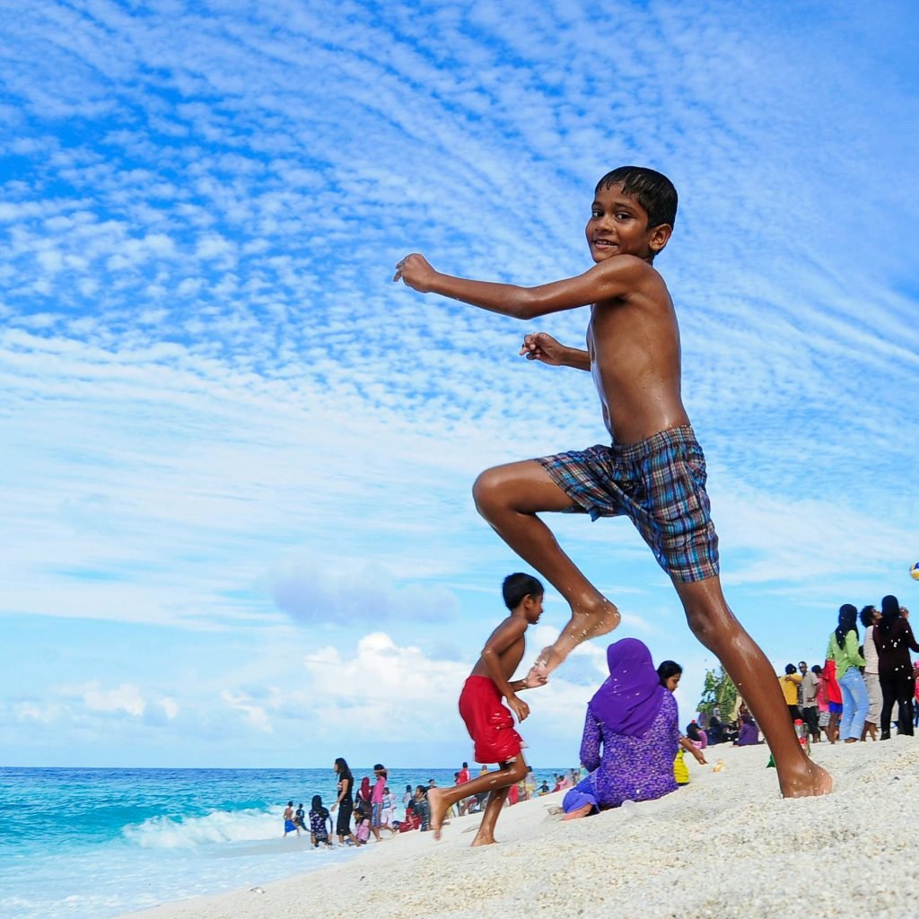 Maldives family playing on the beach